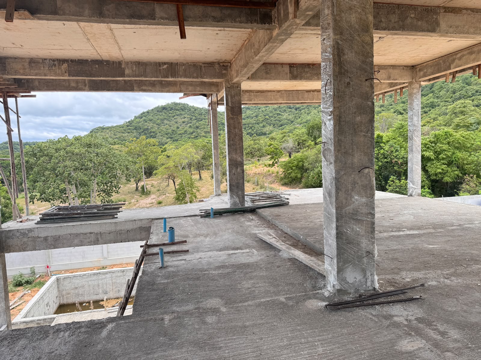 View from the upper level of a villa under construction at The Vista Hua Hin, looking towards the green hills of Hua Hin.