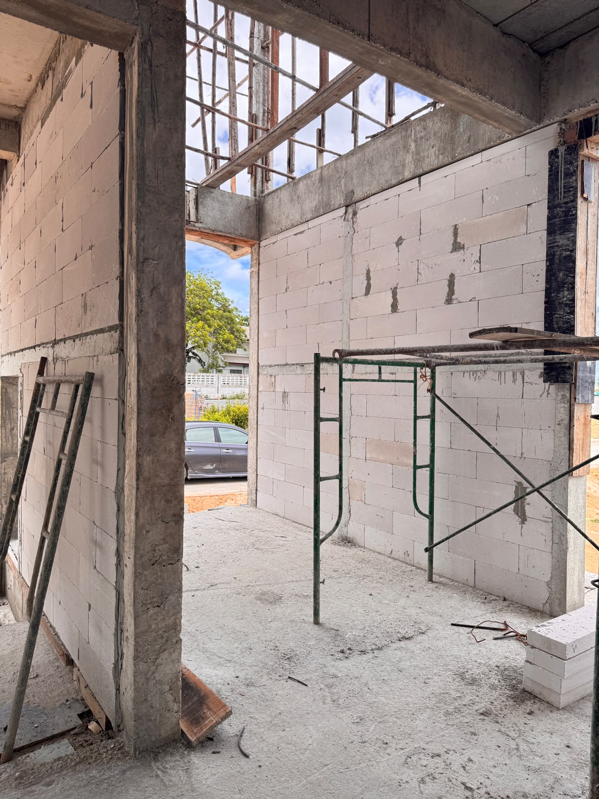 Interior of a villa under construction showing concrete columns, beams and lightweight AAC double cavity walls.
