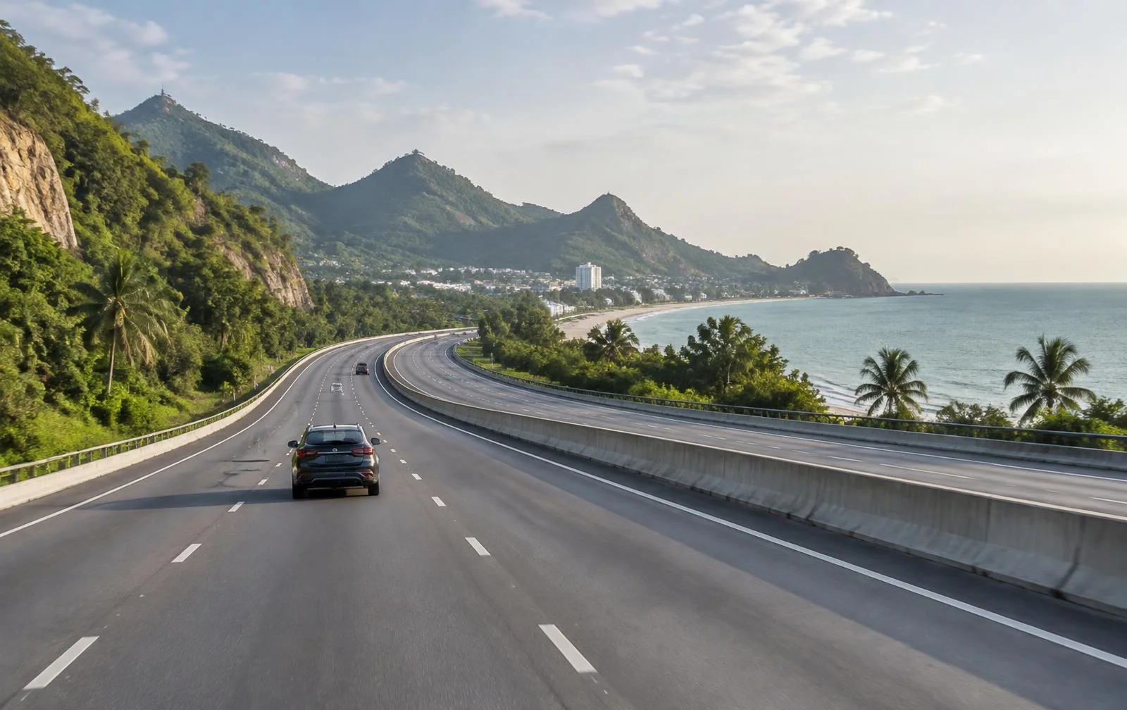 A coastal highway passing through green hills on the journey to Hua Hin